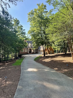 A residential driveway leading to a brick house with a covered porch and a garage. - Family Retreat-Reynolds-Sleeps 12-Bunk Room-Lake Oconee Southern Charm Retreat (Greensboro)