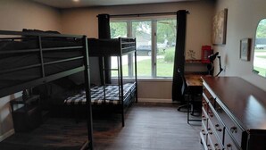 A dormitory room with bunk beds, a desk, and a chair. - Spacious 6 bedroom, 5 bathroom, and 2 game room house on Grand Lake! (Saint Marys)