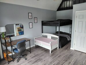 A bedroom with a bunk bed, a desk with a chair, a mirror, and a door. - Spacious 6 bedroom, 5 bathroom, and 2 game room house on Grand Lake! (Saint Marys)