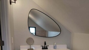 A bathroom with a vanity, a mirror, a sink, and a toilet. - Spacious 6 bedroom, 5 bathroom, and 2 game room house on Grand Lake! (Saint Marys)