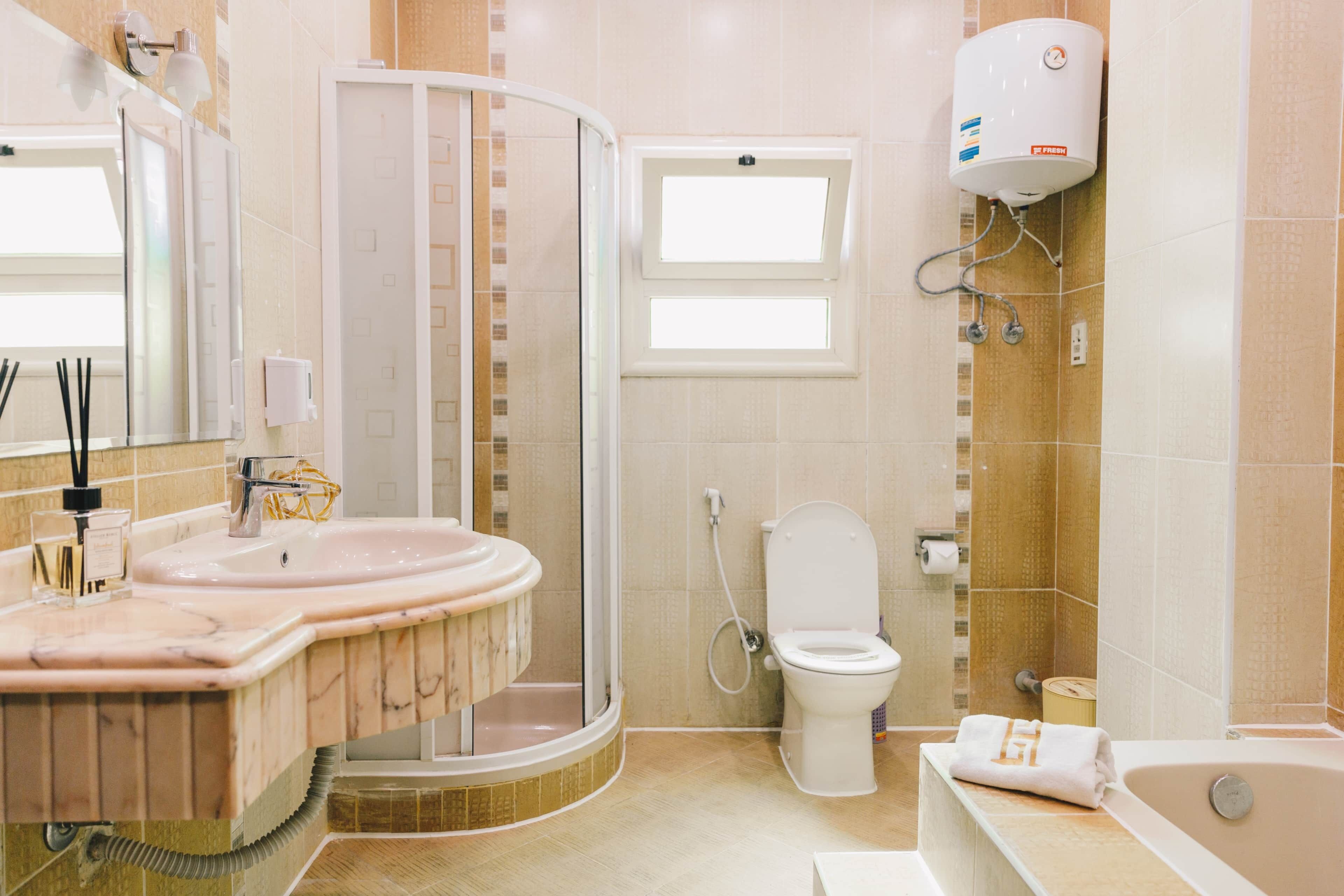 A bathroom with a shower enclosure, a toilet, a sink with a vanity, and a bathtub.