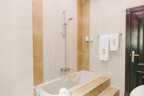 A bathroom with a bathtub, a shower, and a toilet. - Maple and Moon Suite - Comfort & Elegance Stay 3 (New Cairo City)