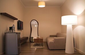 A modern living room with a sofa, a lamp, a mirror, and a small table. - VIOLA Brand New Studio - 44 (New Cairo City)