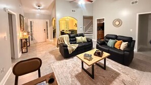 A spacious living room with a ceiling fan, a coffee table, and a sofa. - Near ATL & Stone Mountain/ Sleeps 12/  King Suite (Loganville)