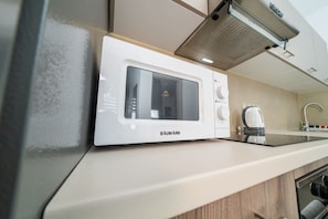 Un four à micro-ondes BAUMANN, posé sur un plan de travail de cuisine, avec un design moderne.