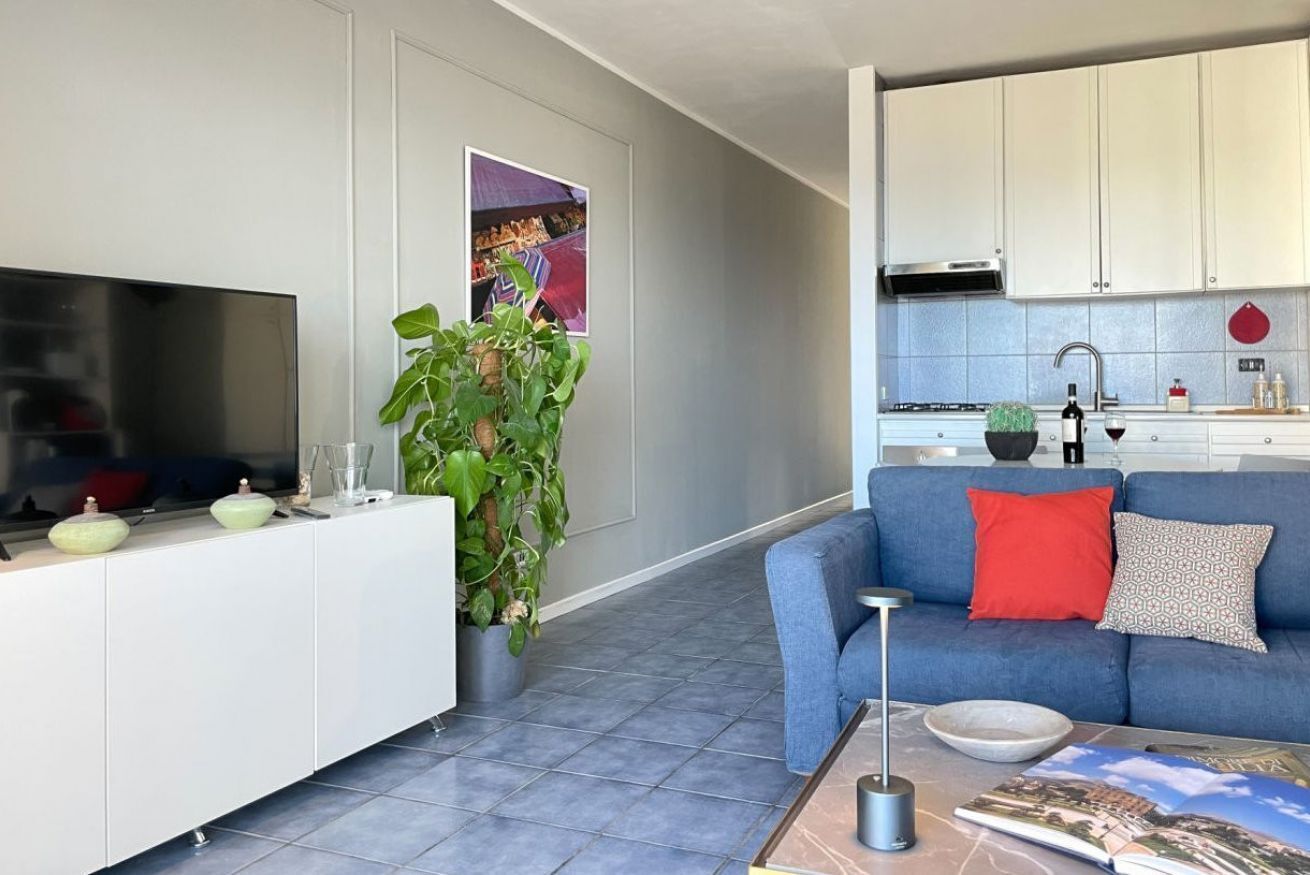 A modern living room with a TV, sofa, and coffee table.