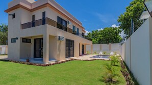 A modern two-story house with a balcony, a swimming pool, and a well-maintained lawn. - 2 or 3 Bedroom - A&E Residence  (Kwale County)