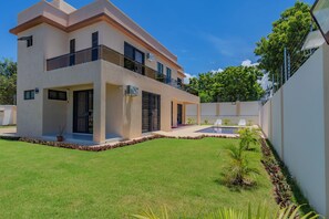 A modern two-story house with a balcony, a swimming pool, and a well-maintained lawn. - 2 or 3 Bedroom - A&E Residence  (Kwale County)