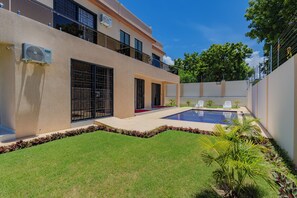 A modern two-story building with a swimming pool, a covered patio, and a well-maintained lawn. - 2 or 3 Bedroom - A&E Residence (Kwale County)