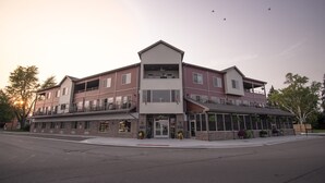 A multi-story hotel with a central entrance, balconies, and large windows.