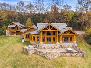 A log cabin with a stone patio and a large deck. - Hamatreya- Panoramic Shenandoah Views (Rileyville)