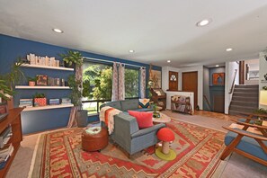 A living room with a sofa, coffee table, and a bookshelf.