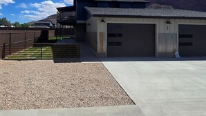 A modern building with a flat roof, two garages, and a covered outdoor area. - Moab Beauty Custom Home (Moab)