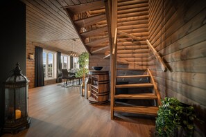 A wooden interior with a spiral staircase, a large window, and a bar area. - The Nordic Retreat - Stryn (Vestland)