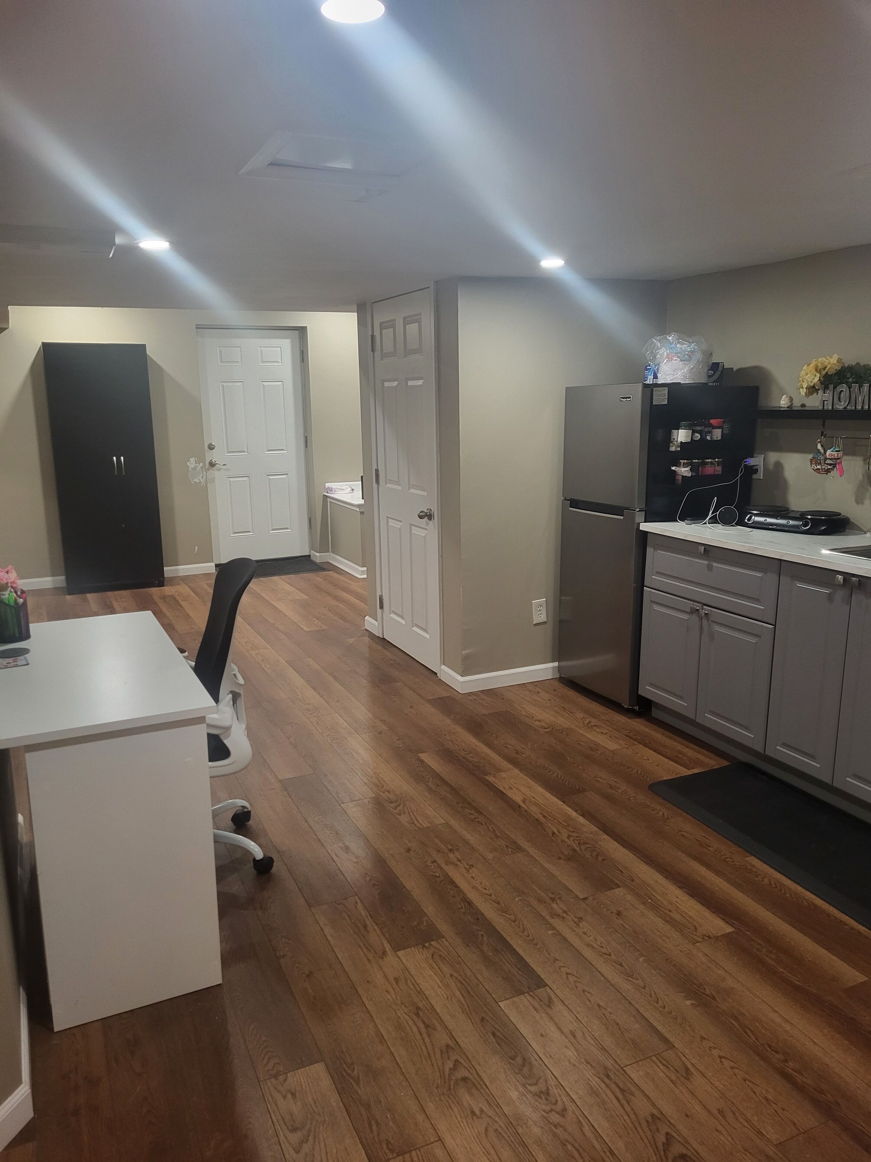 A modern kitchen with a refrigerator, stove, and countertop.