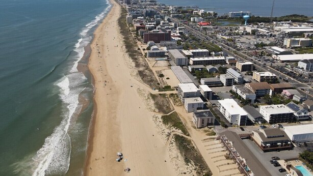 An aerial view of a coastal area with a beach, buildings, and a water tower. - Ocean Block 3BR 2BA | Walk to Beach | Sleeps 8 (Ocean City)