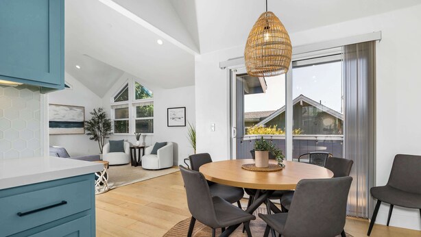 A modern dining area with a round table, grey chairs, and a woven pendant light. - Harbor Home - Walking Distance to Twin Lakes Beach! (Santa Cruz)