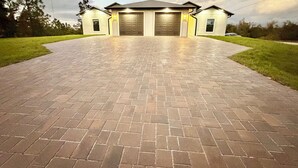 A house with a paved driveway leading to a garage, surrounded by grass and trees. - Sea Salt Cottages AC • Two Luxury Villas • Sleeps 12 next Boca grande Beach (Port Charlotte)