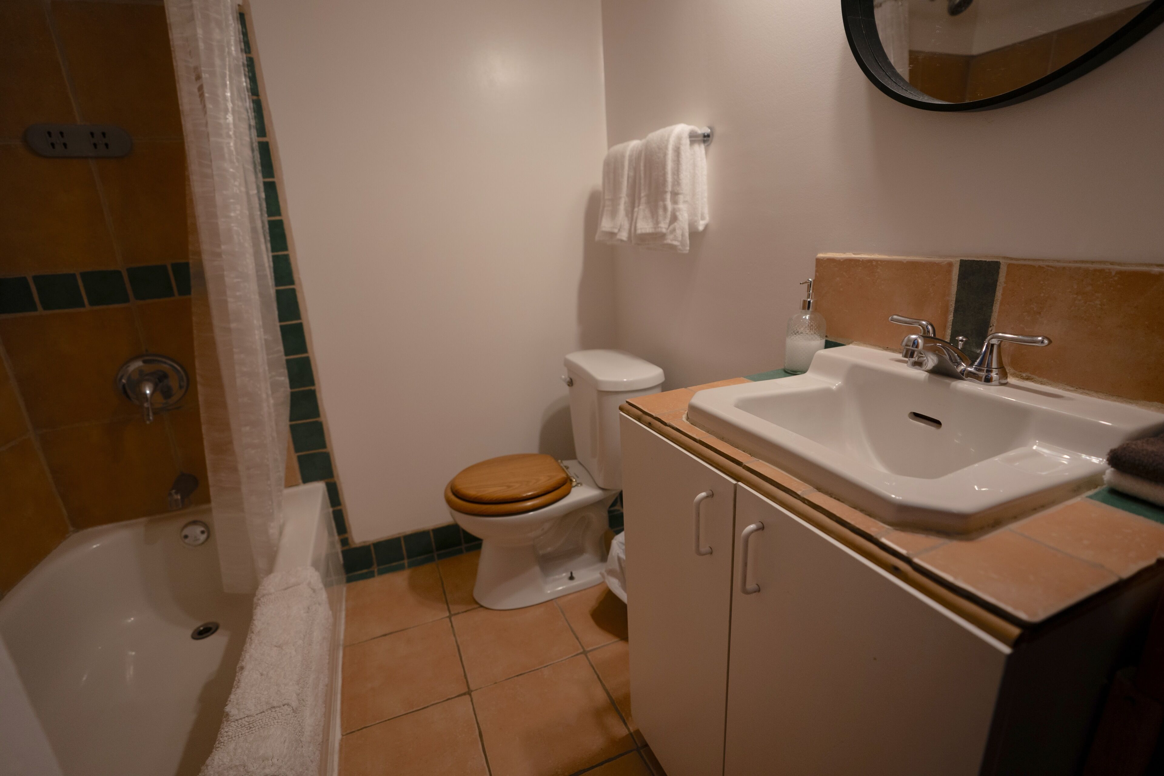 A bathroom with a toilet, sink, and shower.