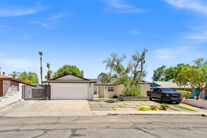 A residential property with a garage, a driveway, and a parked vehicle. - Brighthill Haven | Cozy Studio | 10 Min to Strip (Las Vegas)