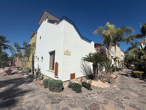A white building with a balcony, a small window, and a door. - AV220 Villa in Loreto Bay. Short walk to Beach, Pools, Restaurants,4 Bikes & AC. (Nopolo)