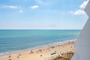 A beach with people, umbrellas, and tents. - Oceanfront 1 Bed/1.5Bath-OutdoorPool-WiFi-Laundry (Ocean City)