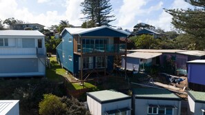 A residential area with multiple houses, some with modern designs and large windows. - Quampi – Unbelievable Main Beach Views (Point Lookout)