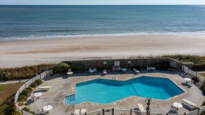 A swimming pool with a view of the beach and ocean.