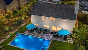 A residential house with a swimming pool, patio furniture, and a well-maintained garden. - OSide Private PoolHome 4bed/3Bth (Oceanside)