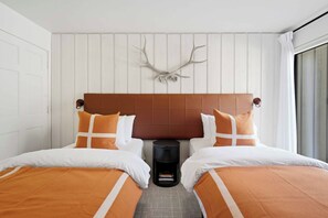 A double bed with a brown headboard, two white pillows, and an orange throw blanket. - Warm Springs Ranch Hideaway | Pool | Ski Access | Mtn. Views (Ketchum)