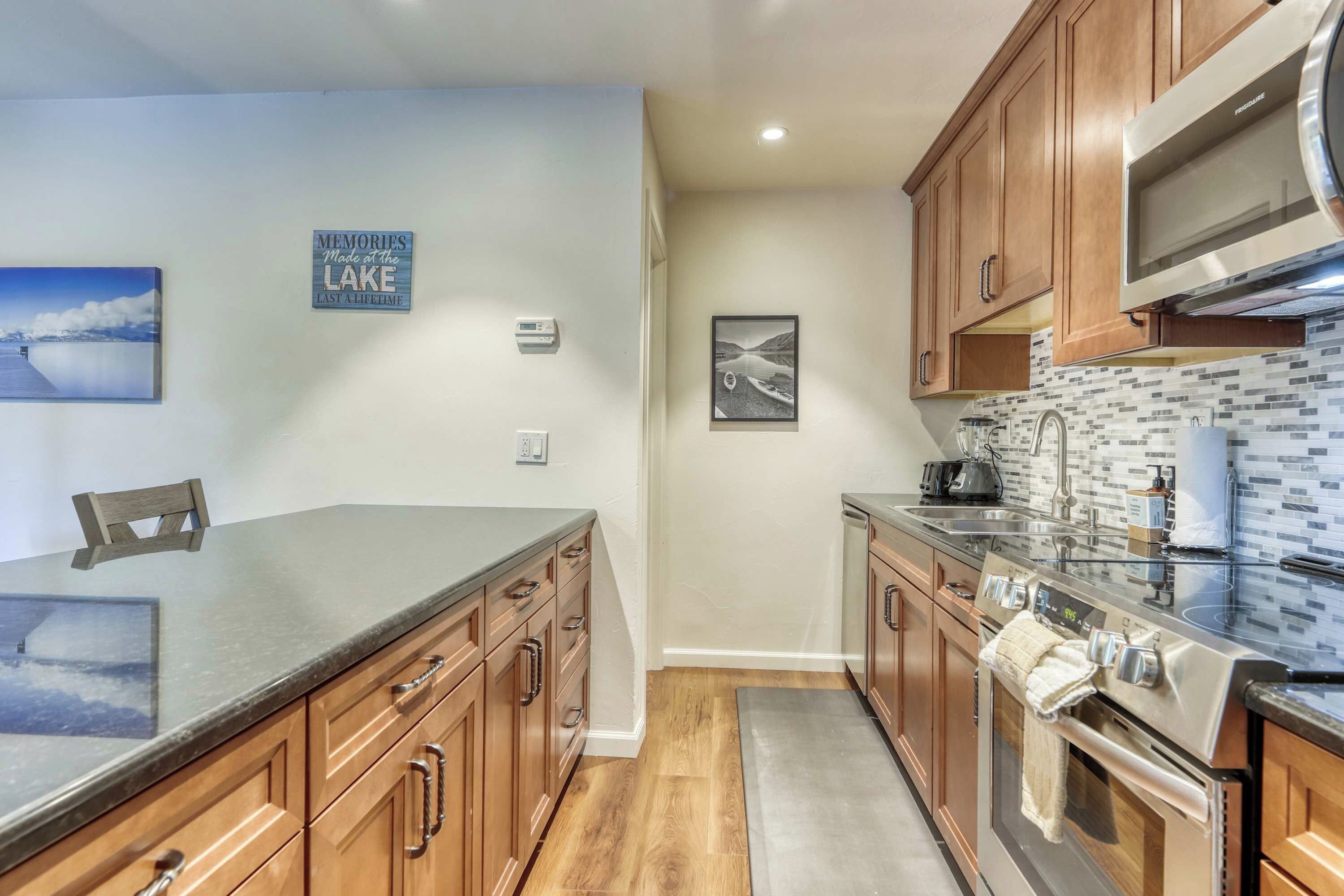 A modern kitchen with wooden cabinets, a stainless steel range, and a tiled backsplash.