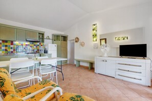 A compact living space with a kitchenette, dining area, and a seating area with a sofa and chairs. - Holiday Home 'Paraiso' with Sea View, Shared Pool and Private Terrace (Costa Paradiso)