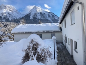 A snow-covered building with a view of snow-capped mountains. - Feriensiedlung Trü 23, (Scuol) by Interhome (Scuol)