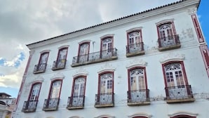 A white building with multiple windows and balconies, featuring a traditional architectural style.