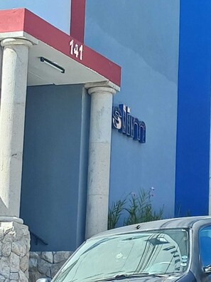 A building with a sign that reads 'slinn' and the number '141' above the entrance.
