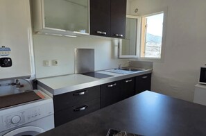 A modern kitchen with a washing machine, a sink, and cabinets. - Dolce & Vita Studio D3 with ocean and pool views (Propriano)