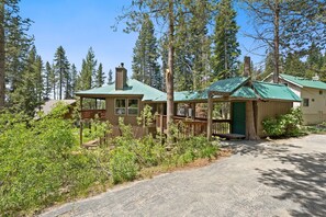 A cabin with a porch, surrounded by trees. - Candal Crest in Tamarack (Big Creek)