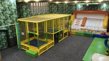 A play area with a trampoline, a climbing structure, and a ball pit.