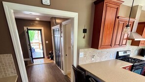 A kitchen with a large island, dark wood cabinets, and a view into the dining area.