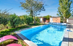 A rectangular swimming pool with a clear blue water surface, surrounded by greenery and a few trees. - Gorgeous home in Sollies-Pont (Sollies-Pont)