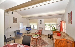 A living room with a television, a sofa, a chair, and a dining table. - Gorgeous home in Sollies-Pont (Sollies-Pont)