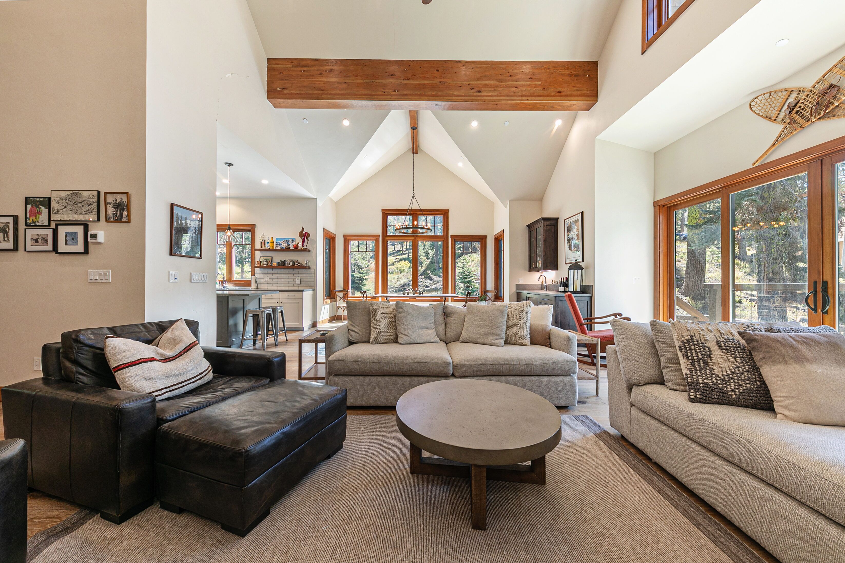 A spacious living area with a large sofa, a coffee table, and a fireplace.