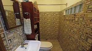 A bathroom with a sink, toilet, and a mirror. - Beautiful, spacious, resort with a secluded garden. (Santander)