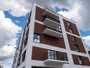 A multi-story building with balconies, large windows, and a modern architectural design.