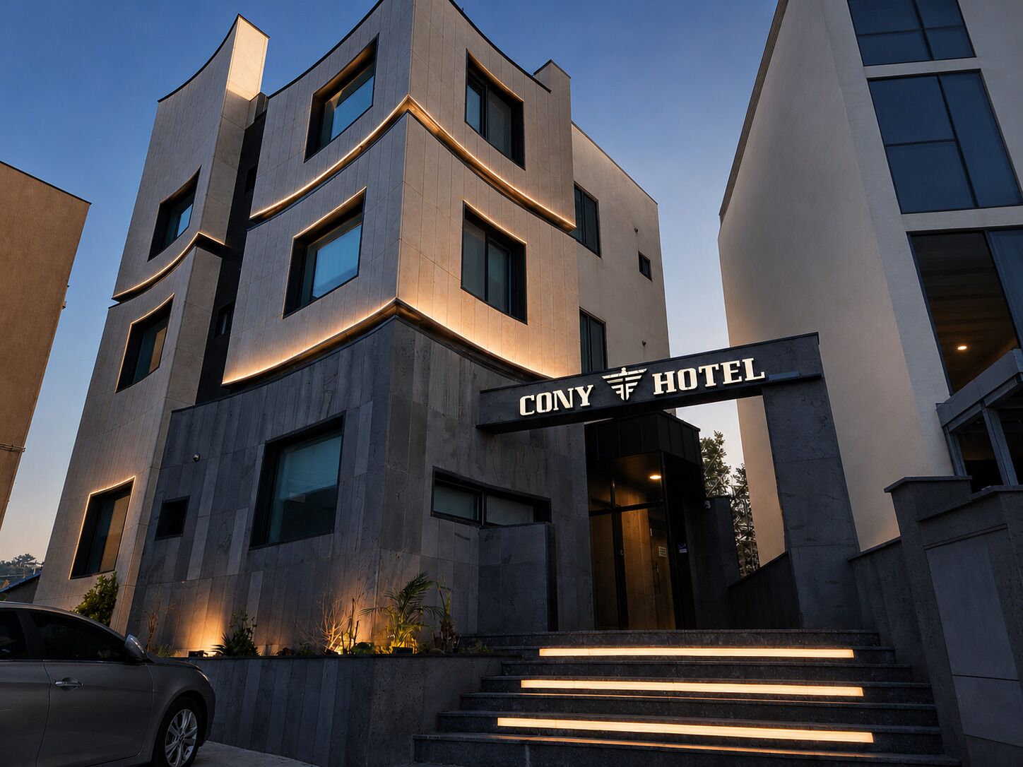 A modern hotel with a prominent entrance, multiple floors, and a clear sign indicating the name.