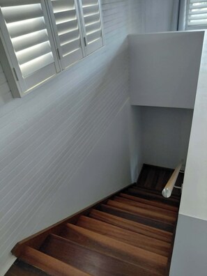 A staircase with wooden steps leading to a landing.