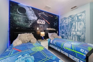 A bedroom with Star Wars themed decor, including a wall mural and bedding. - Dolphin Villa: Pool House Near Disney, Universal, more. Family Fun, Private Pool (Davenport)