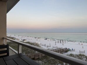 A beach view from a balcony with a railing, wooden deck, and beach access. - Beach Front Paradise/Unobstructed Gulf View From Private Balcony/Pool (Destin)