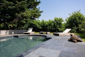 A swimming pool with lounge chairs and a stone sculpture. - Landscove House - Eight Bedroom Villa, Sleeps 16 (Landscove)