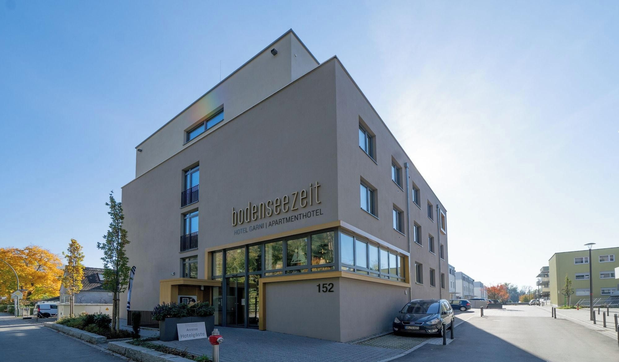Ein modernes Hotelgebäude mit flacher Fassade, großen Fenstern und einem Schild, das es als Hotel kennzeichnet.